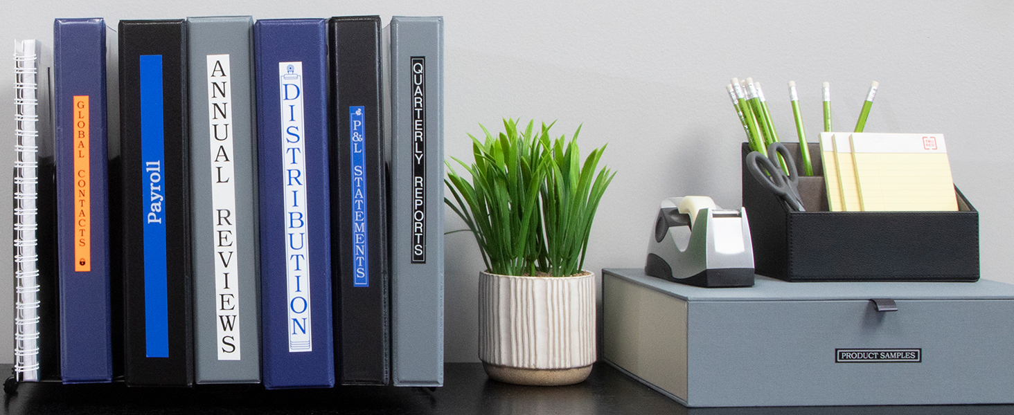 Organized office desk with labeled binders and product samples