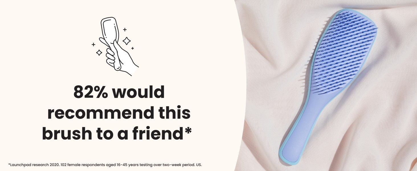A blue ultimate detangler brush laying on fabric with a positive review text overlay.
