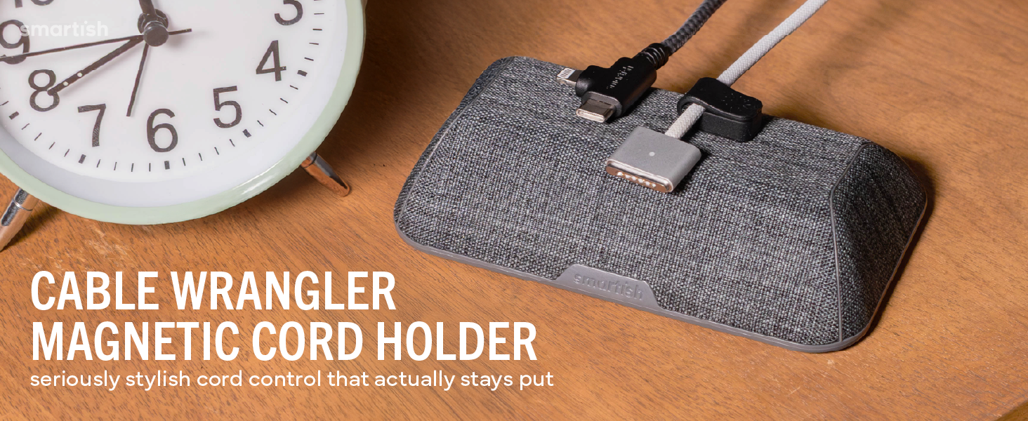 Cable Wrangler magnetic cord holder on wood desk holding USB-C and Lightning cables within reach