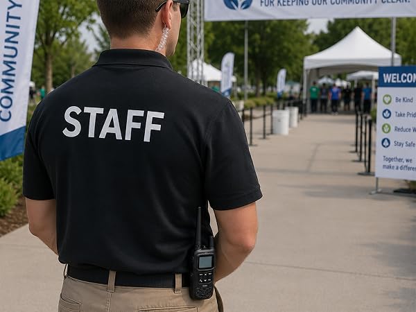 Event staff member using earpiece with FRS-A1 radio clipped at waist
