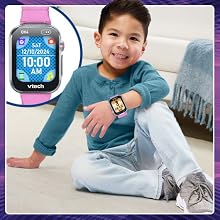 Kid shows off the watch face he has chosen.