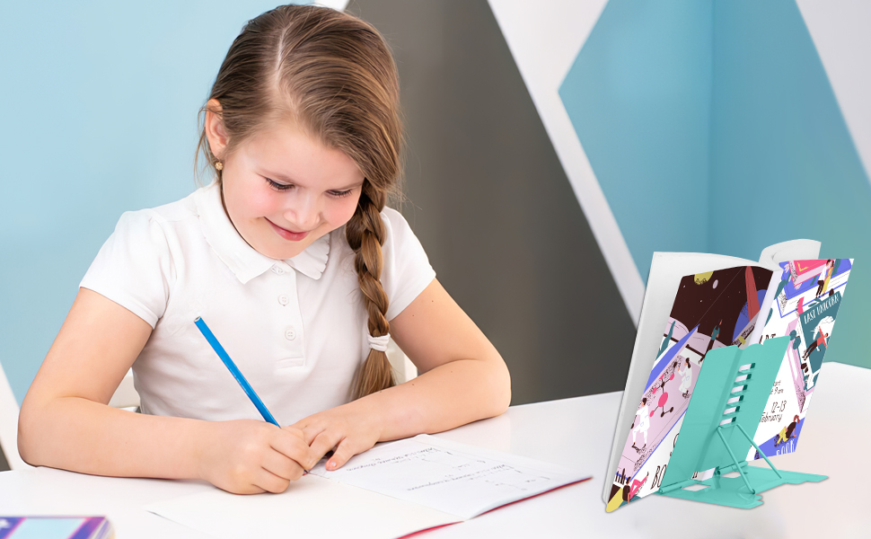 Colorful phone or tablet stand with floral pattern and adjustable angle on a desk, next to writing materials and school supplies.