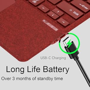 Close-up of a red keyboard with textured surface. USB-C charging port highlighted in green circle. Text indicates long battery life with over 3 months standby time.