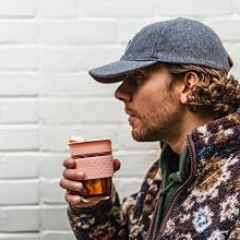 man in a hat drinking a beer