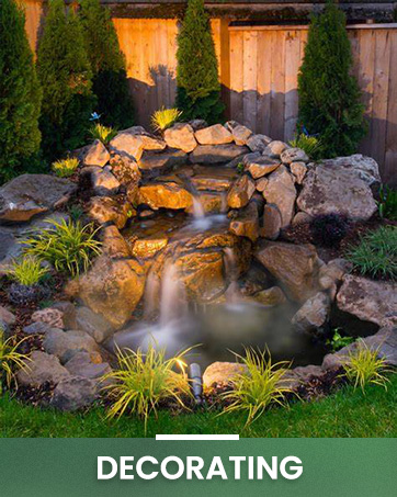 Outdoor water feature with rocks, flowing water, and surrounding plants. Text overlay reads 'Decorating'.