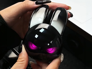 Close-up product-only studio shot of the underside of the burgundy rabbit-shaped wireless mouse, ang