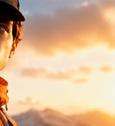 Partial sunset or sunrise landscape photograph with golden-orange sky and silhouetted scenery.
