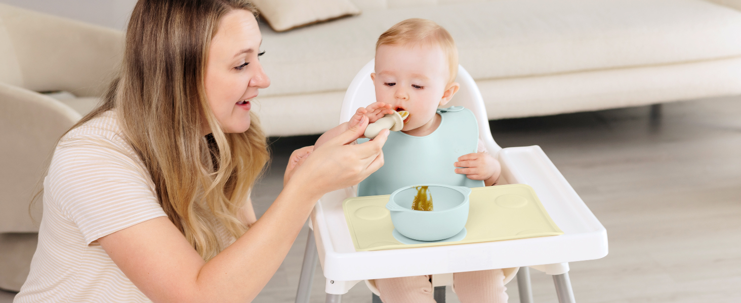 Parent feeding baby using Prep silicone placemat on high chair tray for clean mealtime routine