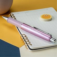 Photo shows Dr. Grip Limited pen resting on a writing pad