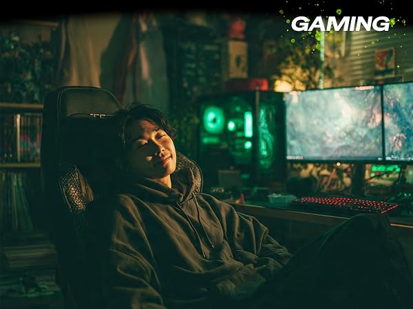 Man smiling at gaming desk using ergonomic mouse pad with wrist rest support