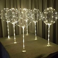 six warm white LED balloons with sticks and stands and battieres