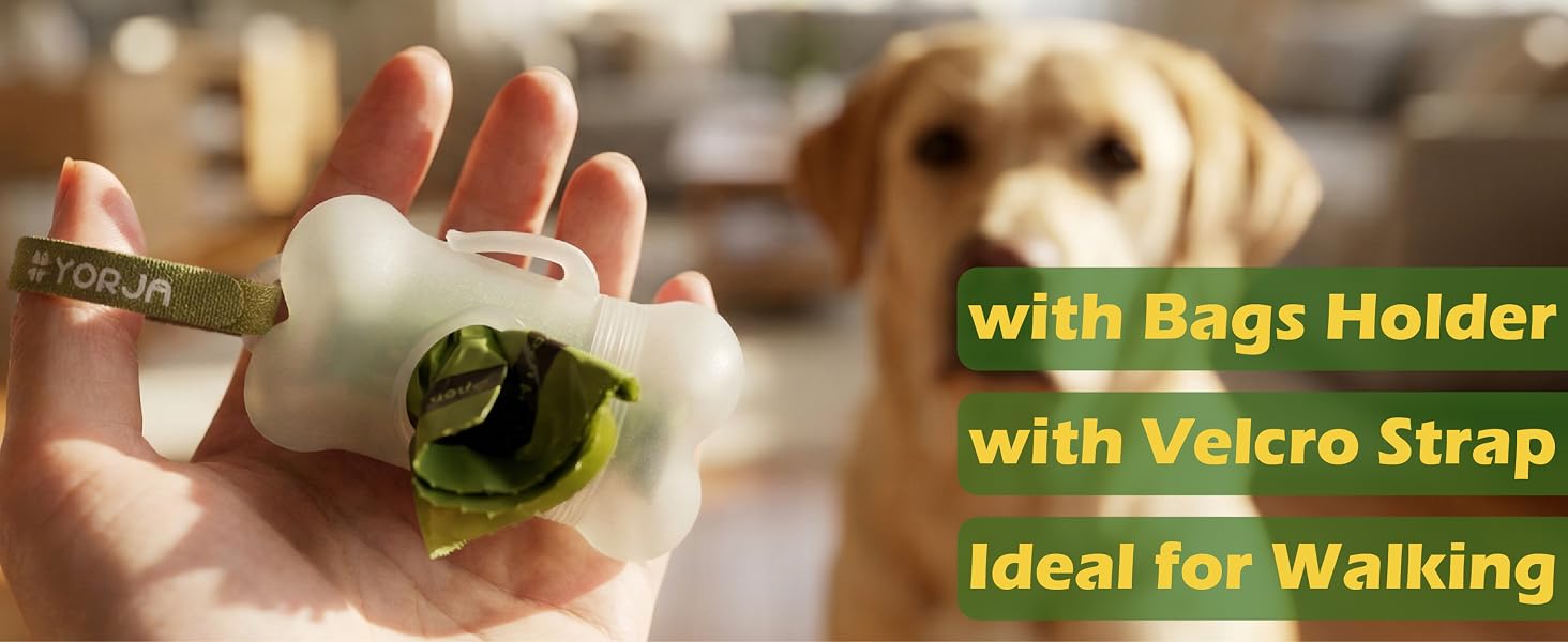 Text reads: 'with Bags Holder', 'with Velcro Strap', 'Ideal for Walking'. White bone-shaped device with green fabric attachment and strap shown in palm of hand, with blurred dog in background.