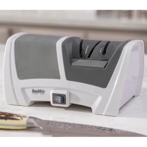 handheld sharpener displayed with tools and knives electric and manual sharpening slots