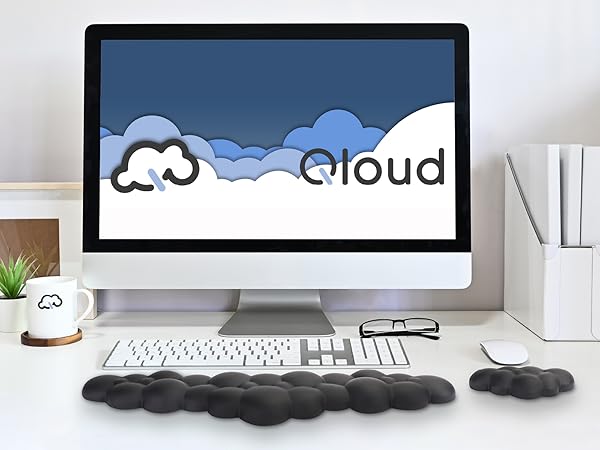 Black cloud wrist rest and mouse wrist rest on neat desk in front of computer with natural lighting