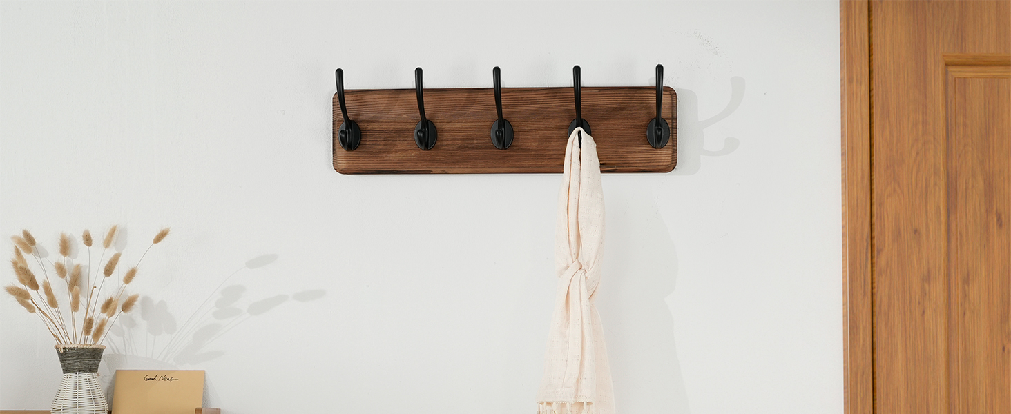 There is a weathered wooden brown wall-mounted coat rack at the entrance to the warehouse