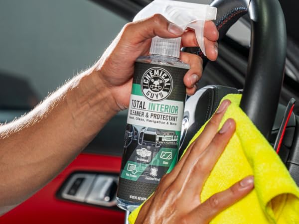 Professional detailer using Total Interior on car interior surfaces
