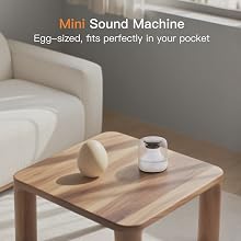 TranquilTone mini white noise sound machine next to an egg for size comparison.