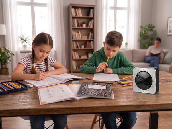 Square visual timer on a wooden desk next to studying children.