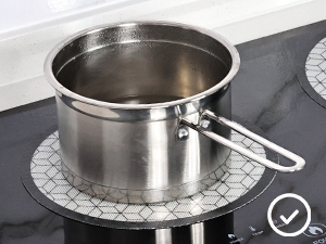a pot of water on a stove top.