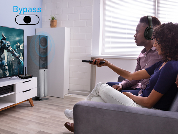 Two people on couch using remote control. 'Bypass' toggle visible in corner.