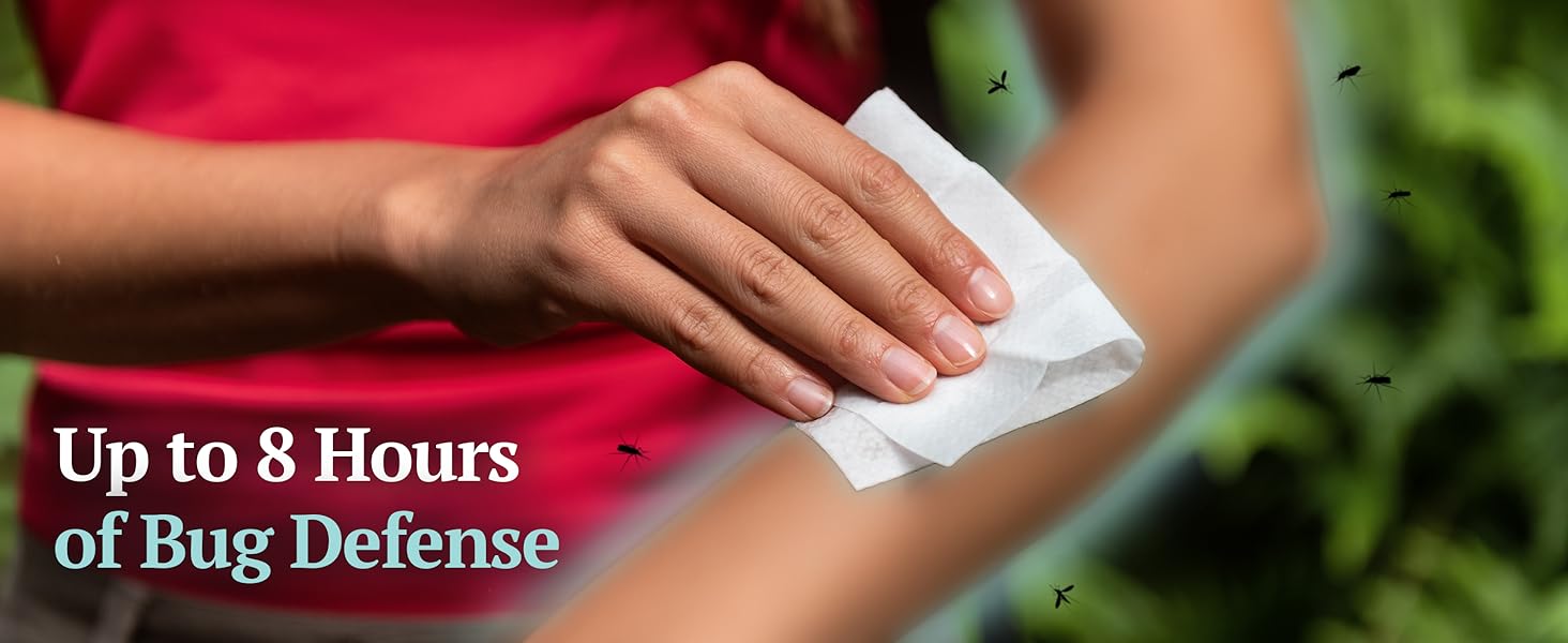Person wiping arm with Wild Guard Mosquito Repellent Wipe while mosquitoes fly nearby outdoors.