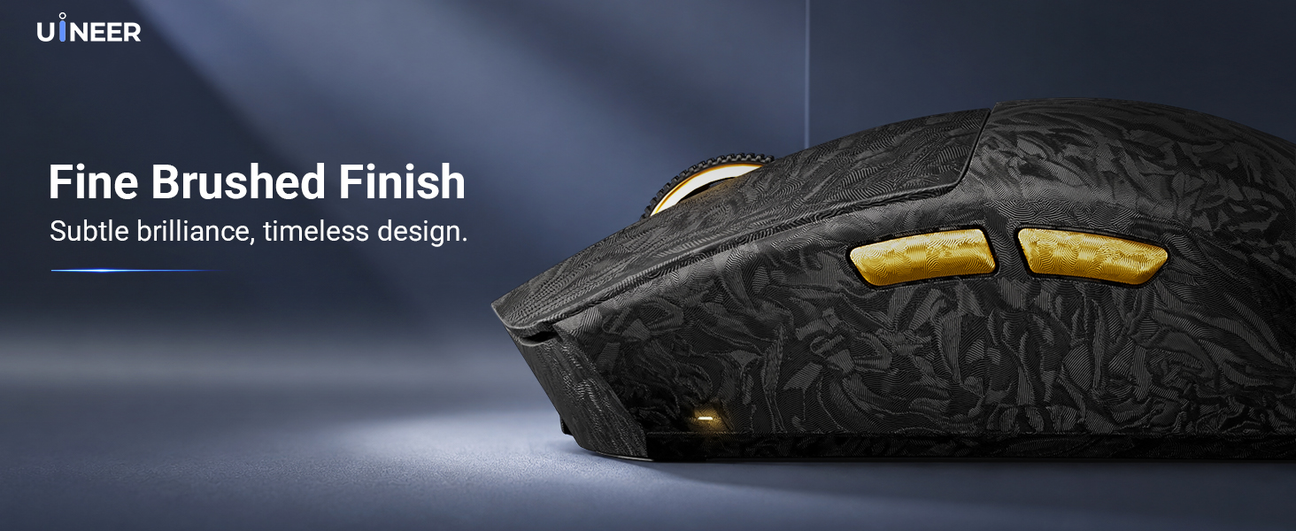 Text reads 'UMBRA' and 'Fine Brushed Finish' with 'Subtle, enchanting, timeless design.' Close-up of black textured product surface with brushed metal finish and gold-toned hardware detail visible.