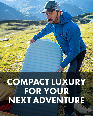 Man inflating a sleeping pad