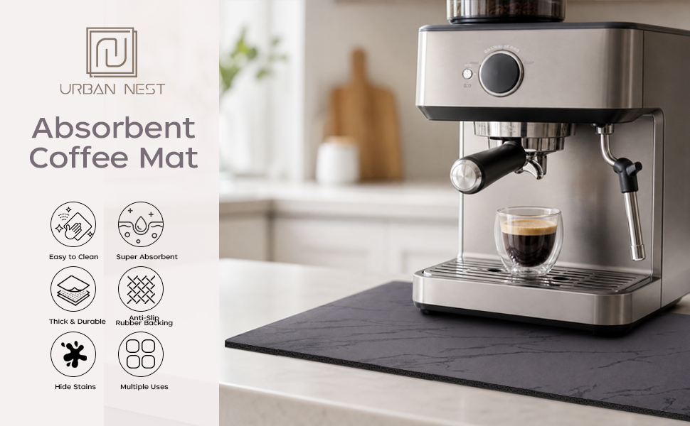 Black marble absorbent coffee mat under an espresso machine on a kitchen counter.