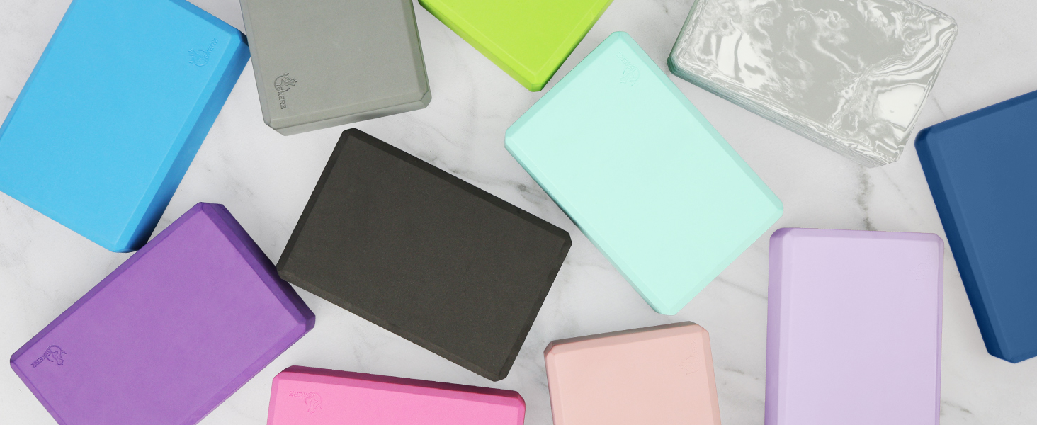 Flat lay arrangement of multiple solid-colored paper or card materials in pastel and vibrant shades including purple, blue, mint green, and pink.
