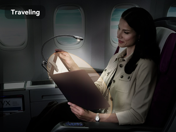 Flexible reading light clipped to airplane seat, illuminating a book. A woman in a white coat uses the light while traveling, demonstrating its portability and functionality.
