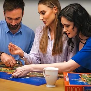 Friends assembling jigsaw puzzles