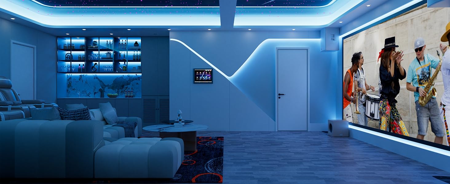 Modern living room with blue LED lighting, large sectional sofa, and wall-mounted projector screen displaying a concert image. Built-in shelving and cabinetry visible in background.