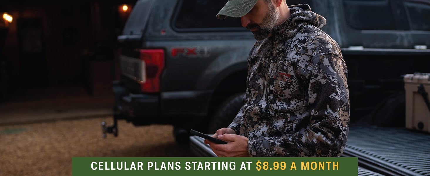 man holding phone activating trail camera
