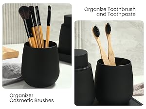 Black ceramic organizer set: Left container holds makeup brushes with wooden handles. Right container holds two bamboo toothbrushes. Minimalist design for bathroom or vanity organization.