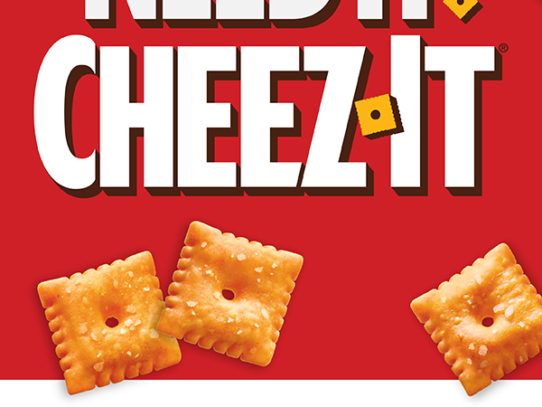 Want It. Need It. Cheez-It logo on a red background with a scattering of Original Cheez-It crackers