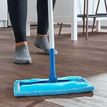 End-user using the Rejuvenate microfiber sweeper pad to clean hardwood floors in home kitchen