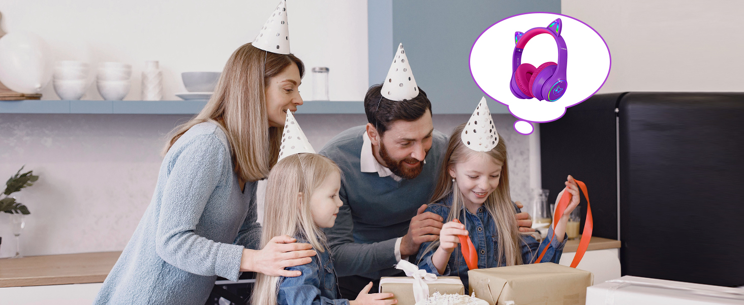 Family celebrating with birthday hats and a cake. Thought bubble shows pink and purple over-ear headphones, likely a gift idea.