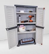 2 door and 3 shelf plastic storage cabinent in the garage with garden tools and supplies