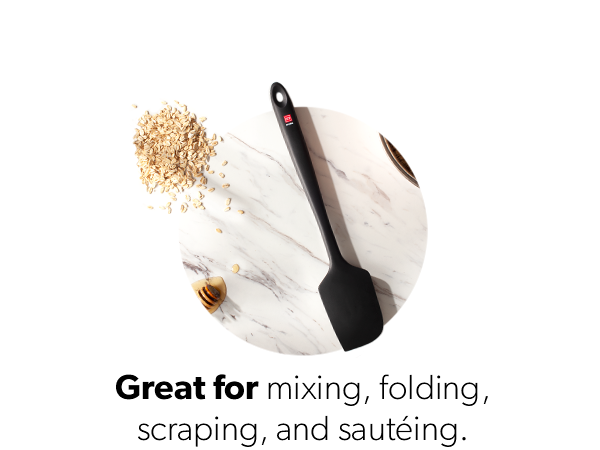image of the pro 14" silicone spatula sitting on a granite countertop with honey and grain
