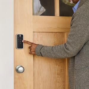Man unlocking door lock with key
