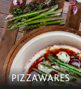a plate of asparagus and a plate of pizza