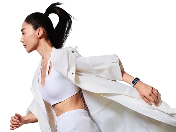 Person wearing white sports bra and leggings, with a white jacket flowing behind them, in a dynamic pose suggesting movement or exercise.