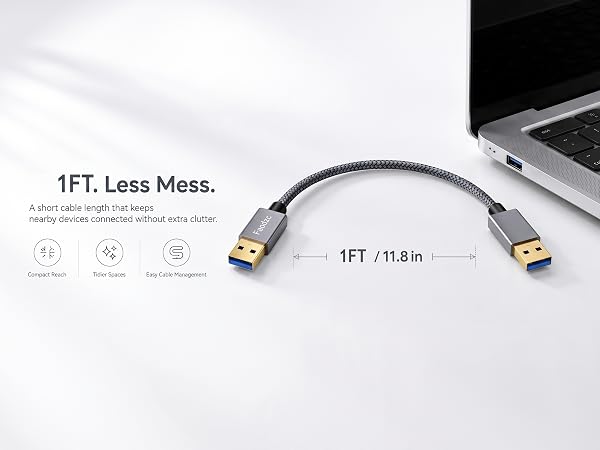 1FT short USB-A cable connecting a laptop to reduce desk clutter.