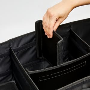 A hand inserts a small divider inside the NINEDUCK trunk organizer.