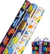 Colorful gift wrapping paper rolls with various patterns including space, animals, and birthday themes. Small gift box visible.