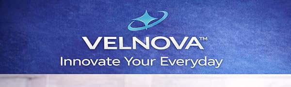 VELNOVA spray and pour oil bottle on a kitchen counter with olive oil and fresh ingredients.