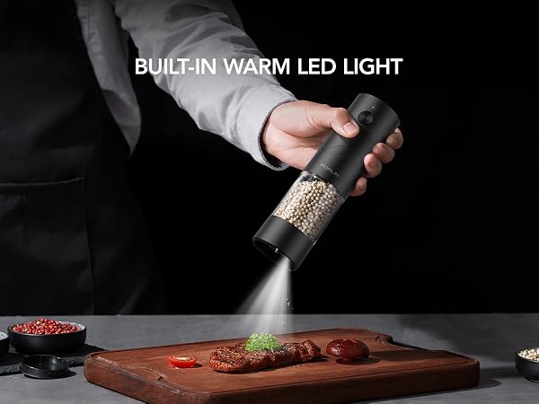 FORLIM electric grinder with built-in white LED light seasoning steak on a cutting board