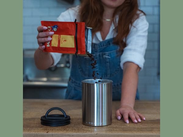 pouring beans into a brushed steel airscape canister