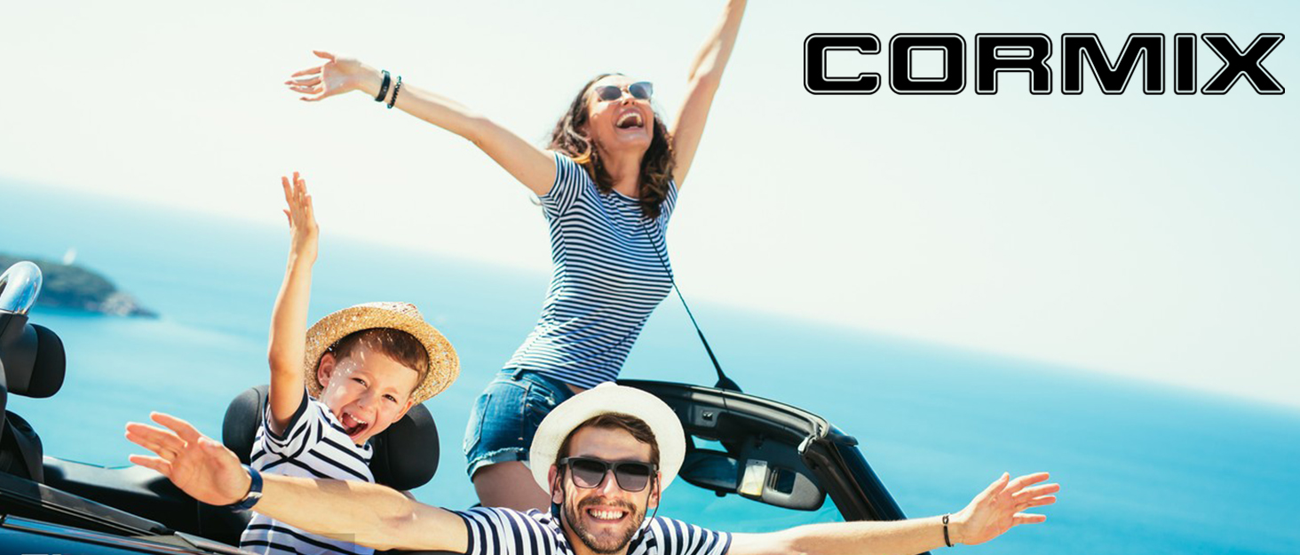 Three people in a convertible car with arms raised, expressing joy. Ocean visible in background. 'CORMIX' text overlay in top right corner.
