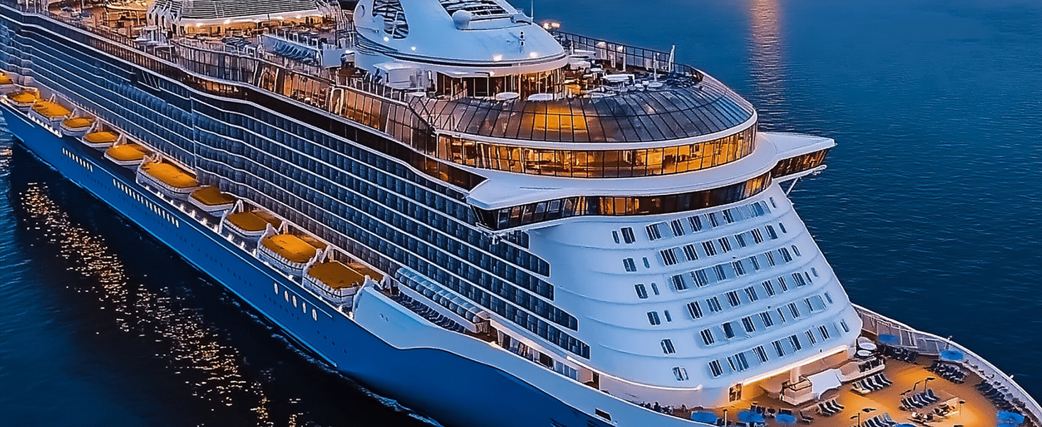 Luxury cruise ship illuminated at night, featuring multiple decks with lit windows and balconies reflected in dark water. Elegant white vessel against twilight sky.